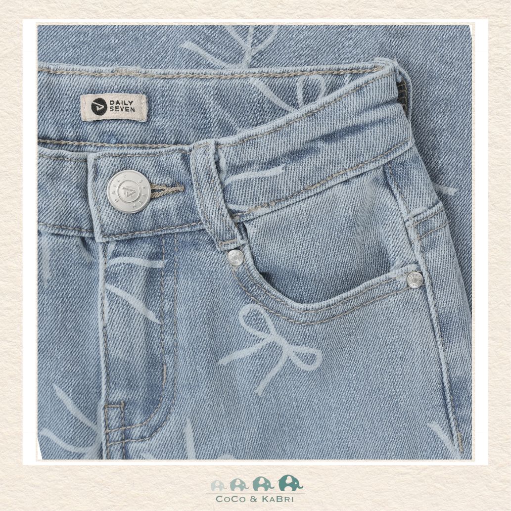 Close-up detail of the Daily7 Jeans highlighting the intricate bow accents and the authentic denim texture