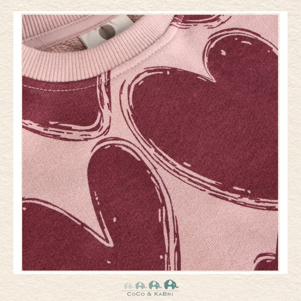 Close-up detail of the En Fant Sweatshirt highlighting the vibrant heart motifs and the premium, soft-touch texture of the fabric