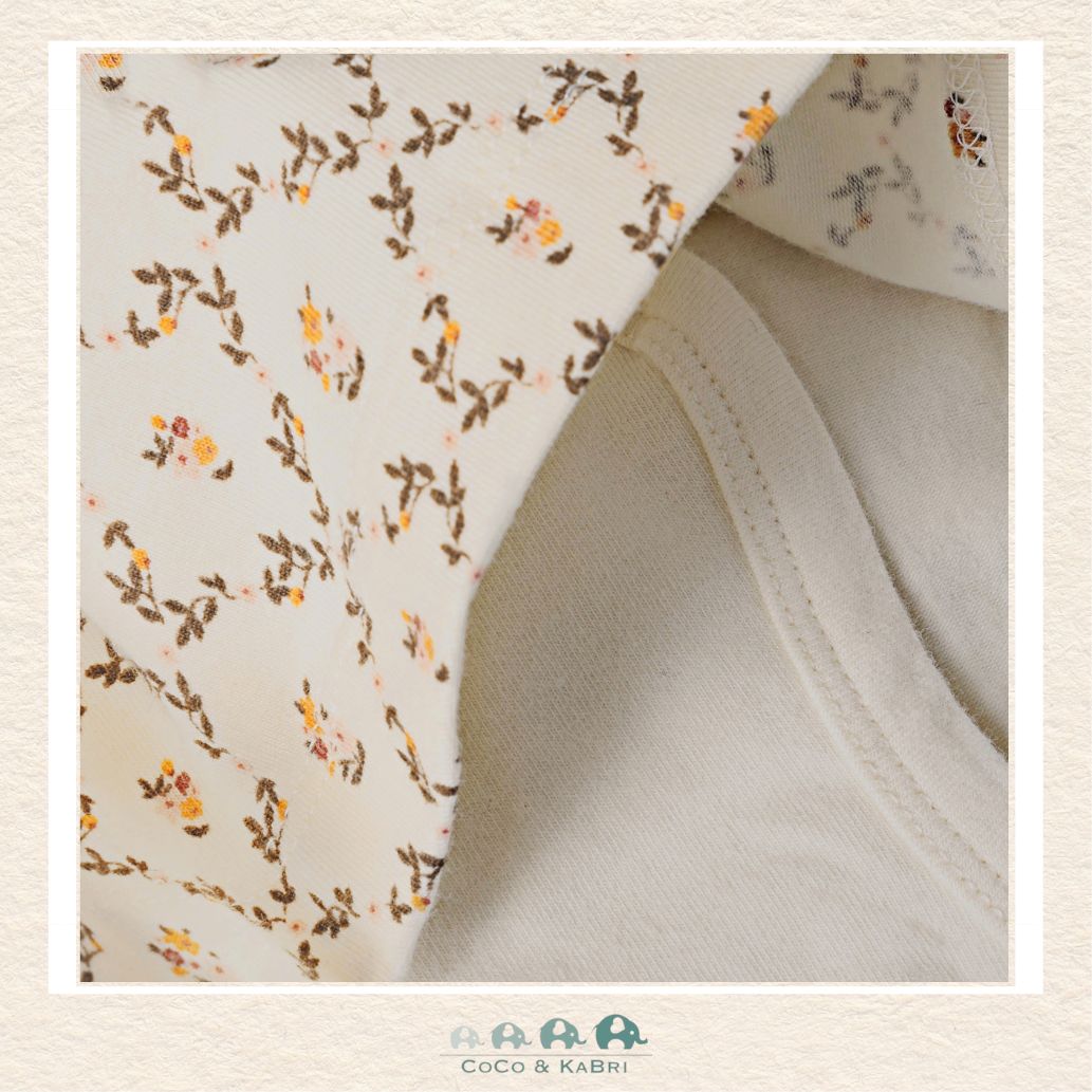 Close-up detail of the Minymo Body Dress highlighting the intricate Seedpearl Floral pattern with soft botanical motifs on a creamy off-white background