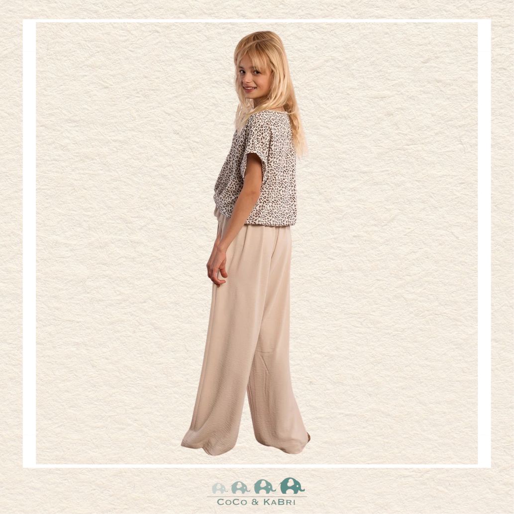 Back view of the model wearing the Molly Bracken flowing pants, demonstrating the clean, tailored waist and the relaxed A-line flare through the legs