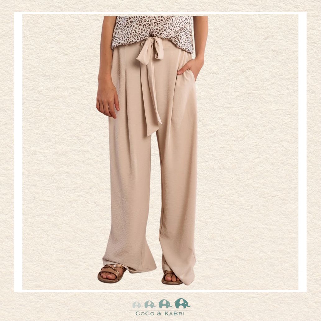 Front view of a girl wearing the Molly Bracken Cream Flowing Pants, showcasing the elegant wide-leg silhouette and the soft, ivory-toned fabric that creates a sophisticated boutique look