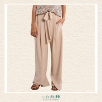 Front view of a girl wearing the Molly Bracken Cream Flowing Pants, showcasing the elegant wide-leg silhouette and the soft, ivory-toned fabric that creates a sophisticated boutique look