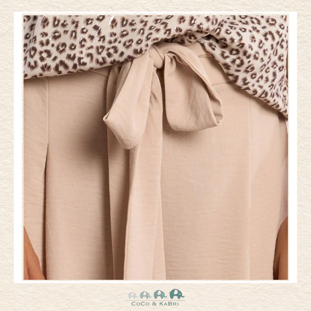 Front view of a girl wearing the Molly Bracken Cream Flowing Pants, showcasing the elegant wide-leg silhouette and the soft, ivory-toned fabric that creates a sophisticated boutique look