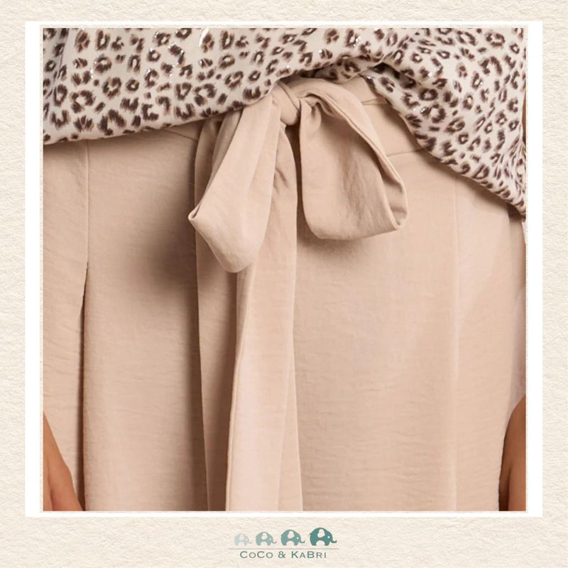 Front view of a girl wearing the Molly Bracken Cream Flowing Pants, showcasing the elegant wide-leg silhouette and the soft, ivory-toned fabric that creates a sophisticated boutique look