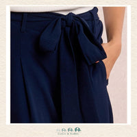 Front view of a girl wearing the Molly Bracken Navy Flowing Pants, showcasing the sophisticated wide-leg silhouette and the comfortable, high-waisted fit