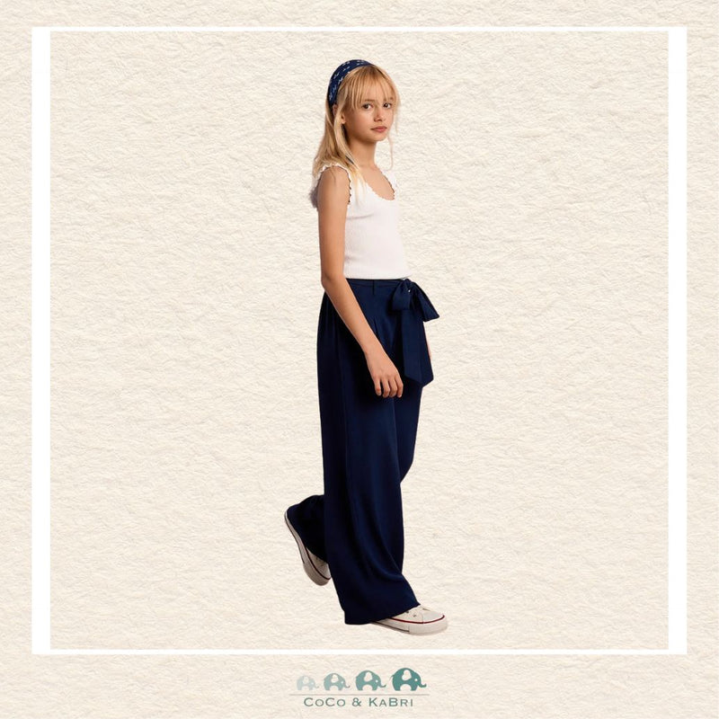 Front view of a girl wearing the Molly Bracken Navy Flowing Pants, showcasing the sophisticated wide-leg silhouette and the comfortable, high-waisted fit