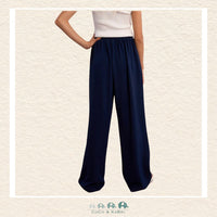 Back view of the model in the Molly Bracken navy pants, demonstrating the clean tailoring and the relaxed yet polished aesthetic of the flowing design
