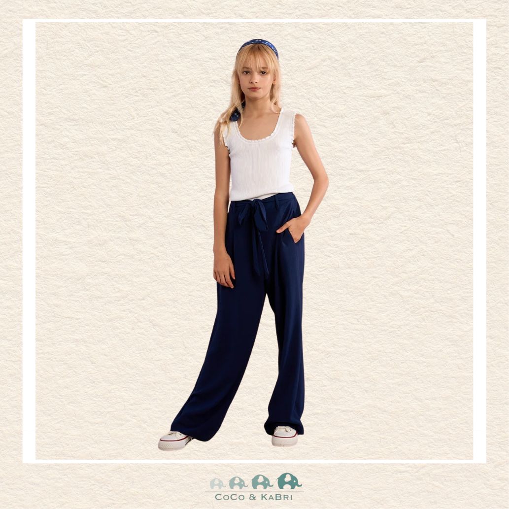Front view of a girl wearing the Molly Bracken Navy Flowing Pants, showcasing the sophisticated wide-leg silhouette and the comfortable, high-waisted fit