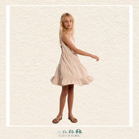 Side profile of the model in the cream woven dress, highlighting the airy ruffled tiers and the perfect fit of the thin adjustable straps