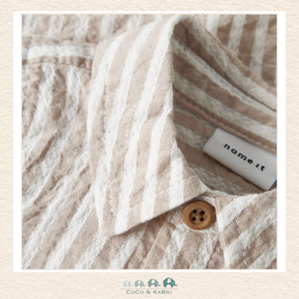 Detailed close-up of the Name It organic cotton weave highlighting the breathable fabric quality and the durable, baby-safe button detailing