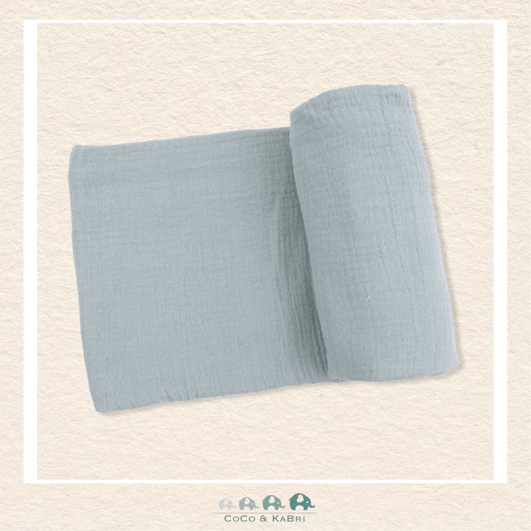 Solid Muslin Jadeite swaddle blanket rolled out showing the breathable open-weave texture and soft, vintage-inspired mint green color | Canada