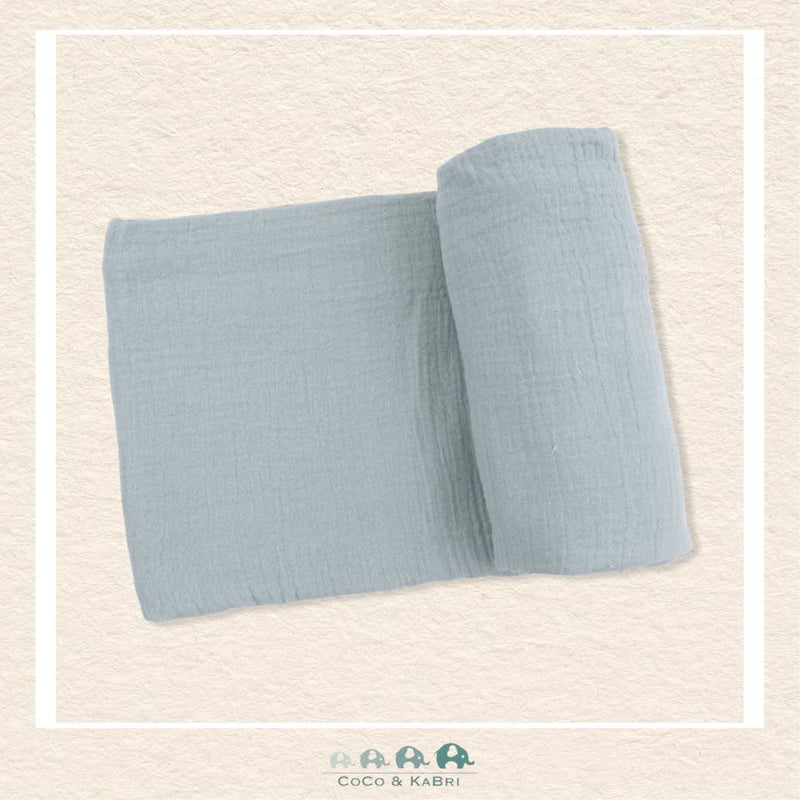 Solid Muslin Jadeite swaddle blanket rolled out showing the breathable open-weave texture and soft, vintage-inspired mint green color | Canada