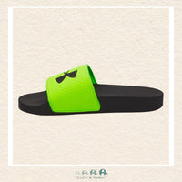 Black and green slide sandal with a bow on a beige background