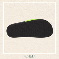Black sandal sole with green accent on a beige background