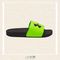 Green and black slide sandal on a beige background